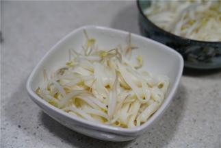 然后将煮好的豆芽面条控水之后入碗里。