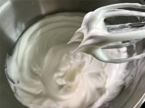 接下来打发蛋白，先用打蛋器把蛋白打到呈鱼眼泡状后分三次加入白砂糖，直至把蛋白打到能拉出一个短小直立的尖角，也说是常说的硬性发泡。