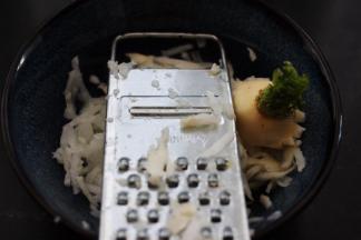 首先把白萝卜洗净后，用擦丝器把萝卜擦成细丝。