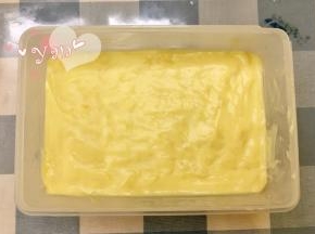 倒入铺好椰蓉的密封盒里；