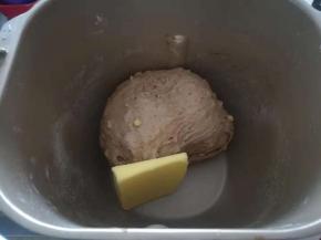 把软化好的黄油放入面包桶。