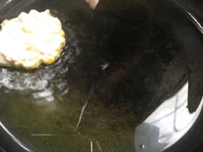 用勺子把玉米糊舀入锅中，大小随意