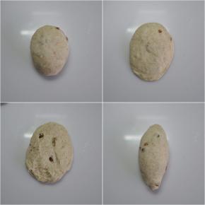 取出一个松弛好的面团，拍扁，翻面后卷起整理成橄榄形