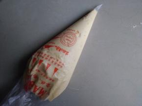 拌好的蛋糕糊装入裱花袋中，不用裱花袋也可以