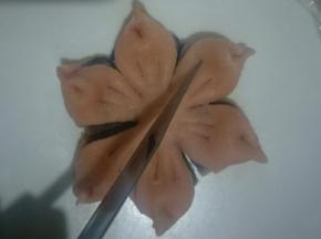 将两端捏起形成花瓣，再在每个花瓣上划两刀