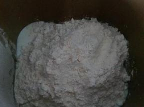 面团食材除了黄油外，都放入面包机桶内，开启揉面程序