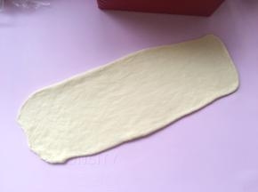 取一份松弛好的面团，用擀面杖擀成长方形；