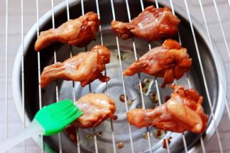 先用刷子蘸少许橄榄油涂抹在鸡根上面，这样烤出来的鸡根颜色柔和不发干。