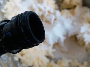 把打蛋盆边缘的黄油用刮刀都刮到中间,再加几滴百利甜酒