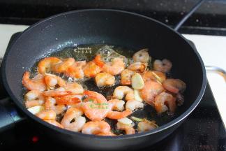 倒入炒熟的虾仁，快速翻转，均匀裹上糖浆，要让每个虾仁都裹上，这样糖醋虾仁才入味好吃。