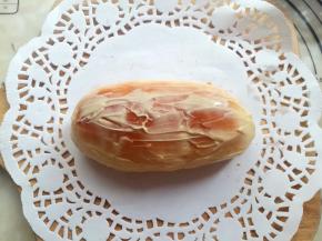 面包烤熟后取出放到手摸起来有余温，在面包上抹适量的沙拉酱