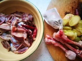 鸡杂洗净，准备生姜，八角，干辣椒，大块生姜切片，常用香料茴香，香果，香叶，白芷等少许，还有剔了肉的鸡骨