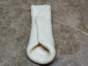 对折，再擀开