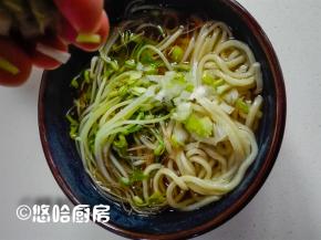 豆芽捞在面条上，浇上适量的面条汤，面条上撒点葱花。