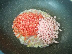  下入红萝卜和午餐肉翻炒均匀。