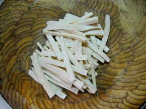 白豆干切宽条。