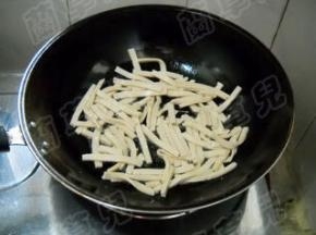 锅中油热，倒入白豆干。
