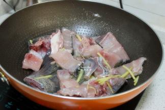 热锅，倒油，把鱼头、鱼尾巴，鱼骨、生姜丝倒入锅里，中小火煎熟，出锅。