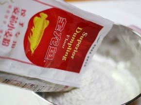 金龙鱼饺子粉倒入大的容器中