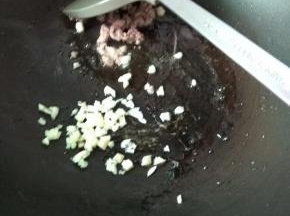 肉沫变色后加入蒜末，炒香
