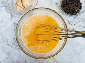 将过筛后的蛋液倒入牛奶混合物中