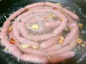 冷水下锅，放入姜片，微火煮至香肠浮起，注意水不要煮开了。