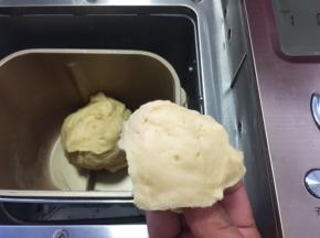 面包机启动揉面程序，将材料揉成面团，一个揉面程序为10分钟，揉好的面团切下一小块，横切面几乎没有孔洞即可