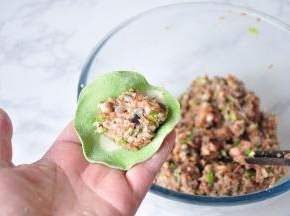 放上调好的饺子馅，馅的量跟据自已的手艺来，初学者不要放太多的馅。