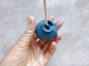 把一块翻糖皮擀成一大张圆形薄片，分成两个半圆，环绕着花心包在上面。