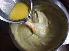 将牛奶黄油沿着橡皮刮刀加入到面糊中，翻拌混合均匀。