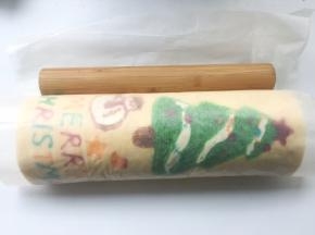 之后借用擀面杖的力度，将蛋糕卷卷起来，卷好后，用擀面杖压一下油纸轻轻收紧，定下形
