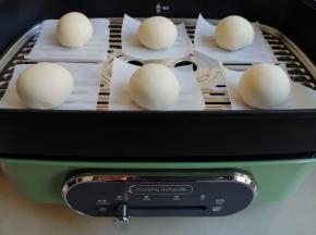 将面团分成6个35克的小面团，揉圆后放在油纸上，再放在蒸屉上，盖上锅盖