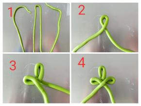 圣诞树做法：取40克绿色面团也是搓成长条，粗细跟筷子差不多，如图所示从中间折一下，左边折回来，右边也同样折回来，如此一左一右一层比一层长一点