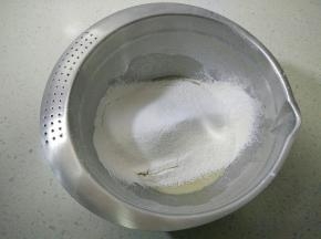 筛入低筋面粉、泡打粉和小苏打，切拌混合至无干粉的面团。