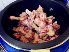 锅里加入油烧热，加入姜片和蒜蓉，倒入鸭块