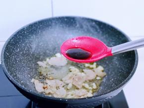 待肉片炒至变色后加入生抽。