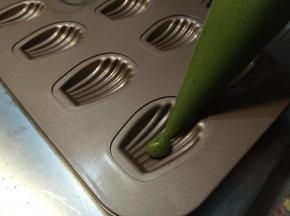 把裱花袋的口压到模具底部，挤到8-9分满。