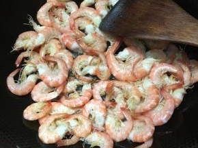 炒至水分收干，转中火继续翻炒。