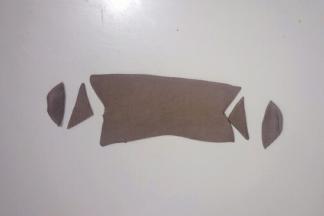 取三分之二奥利奥面团擀成厚度为1mm的薄片，切出如图形状，长度约9cm，宽度约2cm