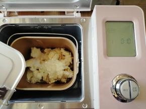 将中种面团撕成小块放入到面包桶里，倒入16克蛋清、30克糖、3克盐、8克奶粉和1克酵母