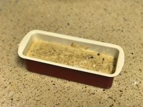 将面糊倒入铺了油纸的模具中，上面撒上芝麻。入炉前震一下消除气泡。配方量是一个7寸模具的量，我做了两倍的。