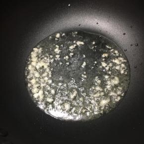 锅里倒入油，大火烧热，下入蒜末煸出香味。