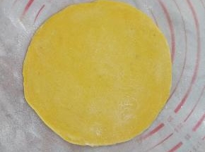 把发酵好的面团重新排气，然后擀成一个圆的薄片。