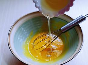 先做蛋黄糊，蛋黄用手动打蛋器打散，加入玉米油，使油和蛋液完全融合再一起，(色拉油也可以，但是一定要无味的)不建议使用黄油或橄榄油。