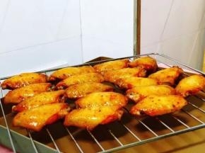 烤了15分钟后取出，在鸡翅的两面刷上蜂蜜水，再放进烤箱烘烤5分钟后出炉，撒上熟的白芝麻就OK了。