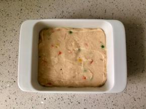 取一个方形的容器，底部和四周抹一层油，然后把鸡肉泥倒进去，用勺子或硅胶刮刀抹平表面。