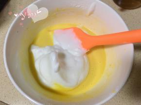 舀一大勺蛋白到蛋黄糊里。