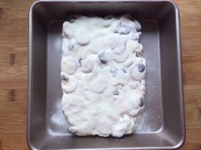 趁余温筛上奶粉在表面，夏天必须放入冰箱冷藏两小时，冬天可以放在室温两小时再切块