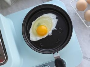 火候按钮旋转至大火，磕入鸡蛋。