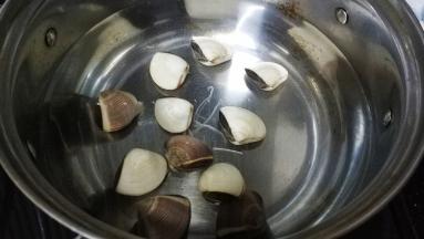 锅里放入适量水，滴入2滴油，放入白贝煮开